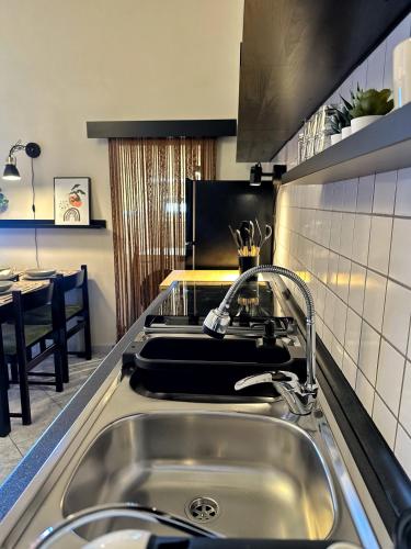 a kitchen sink with a faucet on top of it at VISTA MARE IN CENTRO STORICO Casa di Sara in Sciacca