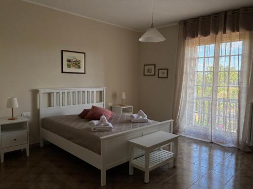a bedroom with a bed with two towels on it at Terrarossa in Crispiano