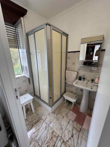 a bathroom with a shower and a sink at Casa da Atalaia in Angra do Heroísmo