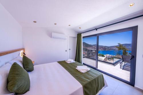 a bedroom with a large bed and a large window at Villa Lovelet 2 in Kas