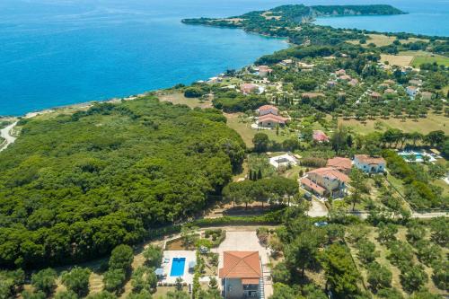 an aerial view of a house on a hill next to the ocean at Loggos Summer House in Vasilikos