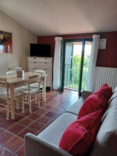 a living room with a couch and a table at Residence Il Melograno in Manerba del Garda