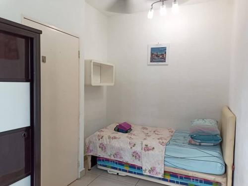 a small bedroom with a small bed in a room at A&M Budget Apt, 5mins to Airport, 8mins to KK City in Penampang