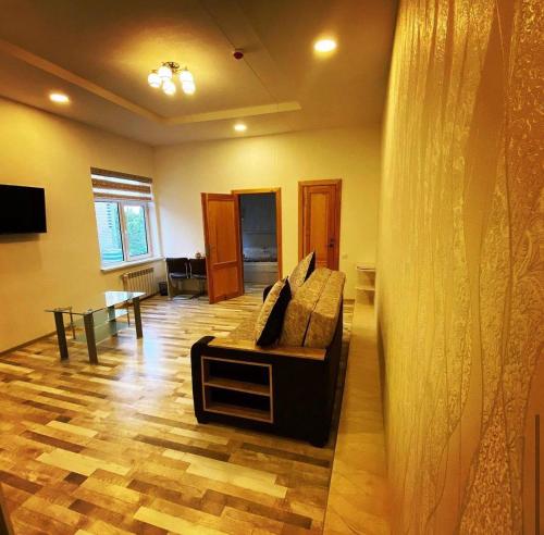 a living room with a couch and a table at Отель Диёр Плюс in Samarkand