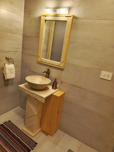 a bathroom with a sink and a mirror at Iris 2 BR Apartment In Batroun in Batroûn