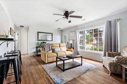a living room with a couch and a table at O-Side Beach Bungalow with Jaccuzi Blocks to beach in Oceanside