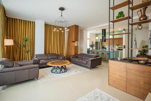 a living room with leather couches and a table at Palase Elite Villas in Himare