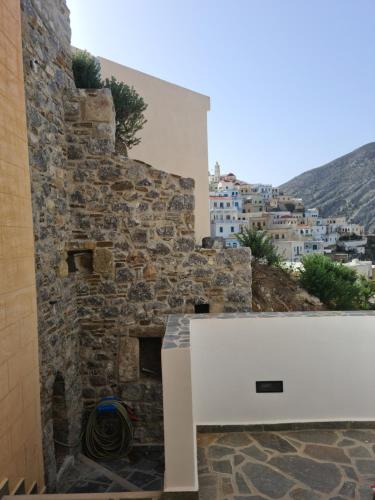 a stone wall with a white bench in front of a building at Olympos Sunrise in Olympos