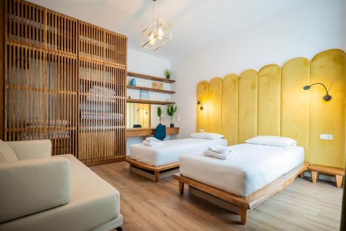 a room with two beds and a couch at Palase Elite Villas in Himare