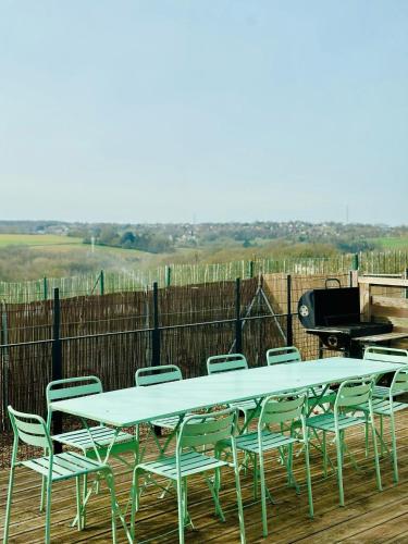 a table and chairs on a deck with a grill at Little Farm Comfort&PrestigeHouse in Ittre