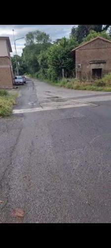 an empty street with a building on the side of the road at La Dimora Di Ale in Monterosi