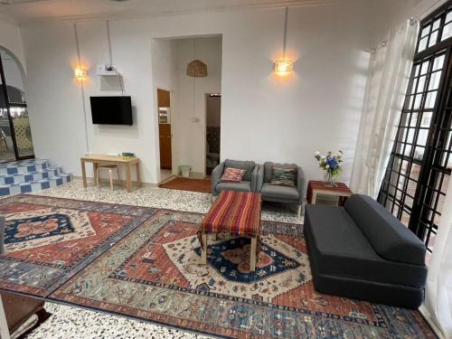 a living room with a couch and a table at Casa Syukur in Cukai