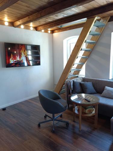 a living room with a couch and a chair at Ferienhaus hERZgebirge in Bockau