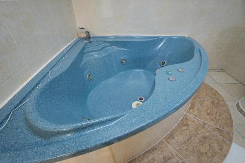 a blue bath tub sitting in a bathroom at BnB rooms in downtown Cancun- Casa Sunshine Cancun in Cancún