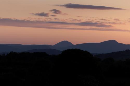 a sunset with mountains in the background at 1 bedroom Apartment Ballaghderg Letterkenny in Letterkenny