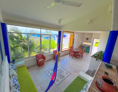 a living room with a large window and an umbrella at Villa Ballam 7, Balcones, bahías de Huatulco, Oax in Bahías de Huatulco