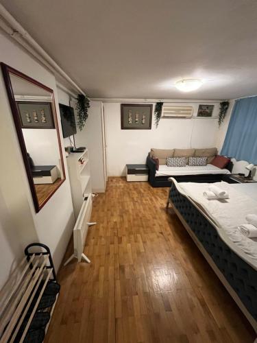 a small room with two beds and a couch at İstanbul apartment 1 in Belgrade