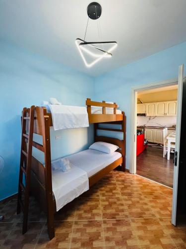 a bedroom with two bunk beds in a room at Beachfront Bliss Central 2BR Apartment in Durrës
