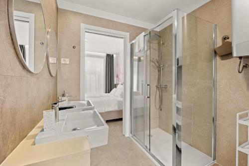 a bathroom with a sink and a shower at Calypso Residence in Umag