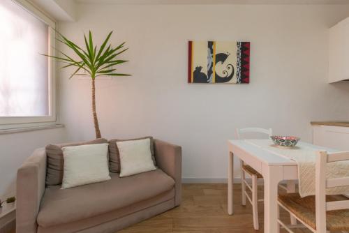 a living room with a couch and a table at Villanova Apartment in Cagliari