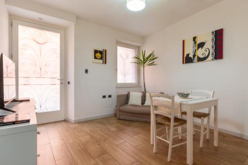 a living room with a table and a couch at Villanova Apartment in Cagliari