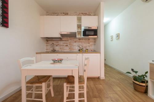a kitchen with a table and chairs in a room at Villanova Apartment in Cagliari