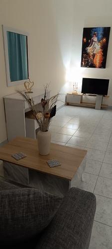 a living room with a table and a couch at Pyrgos Hotel Apartments in Kremasti