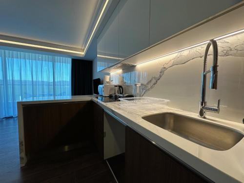 a kitchen with a sink and a counter top at Grand Sapphire Luxury Residence By MyGuest Cyprus in Iskele