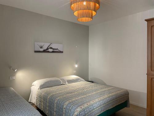a bedroom with a bed and a painting on the wall at labotanica_casalounge in Cesenatico