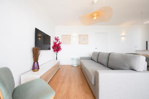 a living room with a couch and a table at Skymar Palmeras 2 bedrooms & pool by 10Tosea in Fuengirola