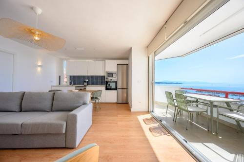 a living room with a couch and a table with chairs at Skymar Palmeras 2 bedrooms & pool by 10Tosea in Fuengirola