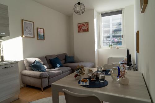 a living room with a couch and a table at Blu Milano Relax Apartment in Milan