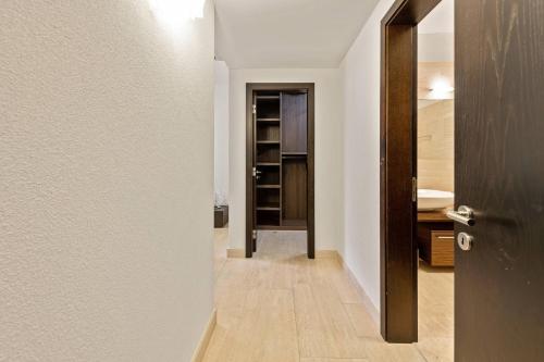 a hallway with a door leading to a bathroom at Luxurious Lugano Apartment with City Views in Lugano