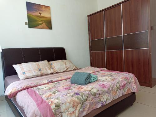 a bedroom with a bed with a wooden cabinet at A&M Budget Apt, 5mins to Airport, 8mins to KK City in Penampang