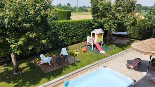 an aerial view of a backyard with a pool and a playground at Country Relais Villa Margherita in Pralormo