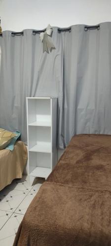 a bedroom with a bed and a white dresser at Studio 202 Cop 30 in Belém