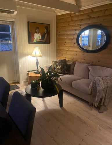 a living room with a couch and a table at Ingeborgstova in Lii