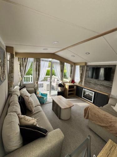 a large living room with a couch and a tv at Luxury Caravan - Sleeps 8 - Haven Cala Gran - Close to Blackpool in Blackpool