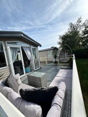 a patio with a couch and two chairs at Luxury Caravan - Sleeps 8 - Haven Cala Gran - Close to Blackpool in Blackpool