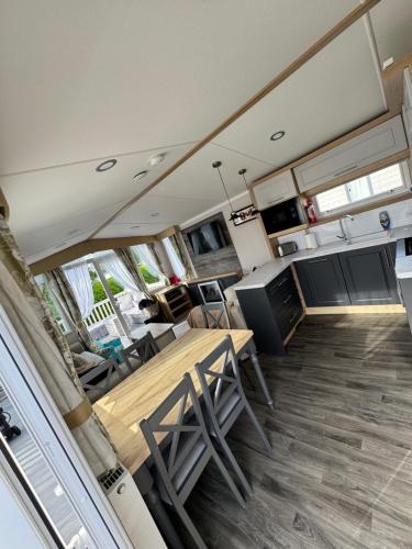 an interior view of an rv with a table and chairs at Luxury Caravan - Sleeps 8 - Haven Cala Gran - Close to Blackpool in Blackpool