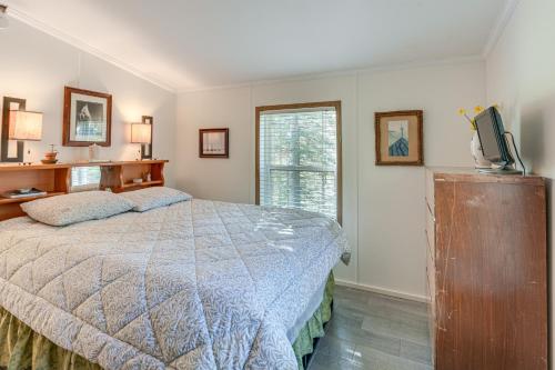 a bedroom with a bed and a television in it at 13 Mi to Acadia Artistic Retreat in Nature in Trenton