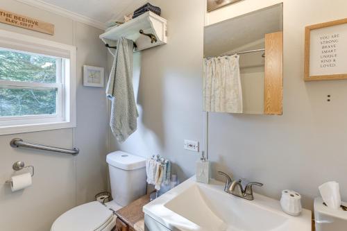 a bathroom with a sink and a toilet and a mirror at 13 Mi to Acadia Artistic Retreat in Nature in Trenton