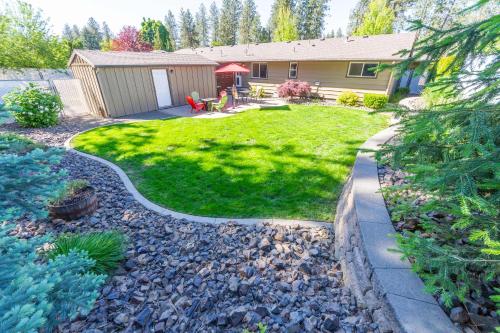 a yard with a house and a lawn with rocks at Spacious 3BR Family Retreat w Fire Pit BBQ Smart TVs & More in Spokane Valley