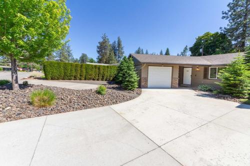 a house with a driveway and a garage at Spacious 3BR Family Retreat w Fire Pit BBQ Smart TVs & More in Spokane Valley