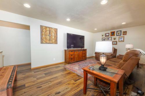 a living room with a couch and a tv at Spacious 3BR Family Retreat w Fire Pit BBQ Smart TVs & More in Spokane Valley