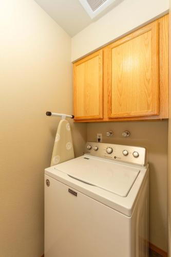 a small laundry room with a washer and dryer at Spacious 3BR Family Retreat w Fire Pit BBQ Smart TVs & More in Spokane Valley