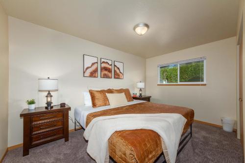 a bedroom with a large bed and a window at Spacious 3BR Family Retreat w Fire Pit BBQ Smart TVs & More in Spokane Valley