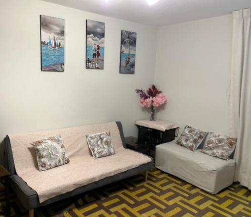 a living room with a couch and a table at Suite vista al mar San Miguel in Lima