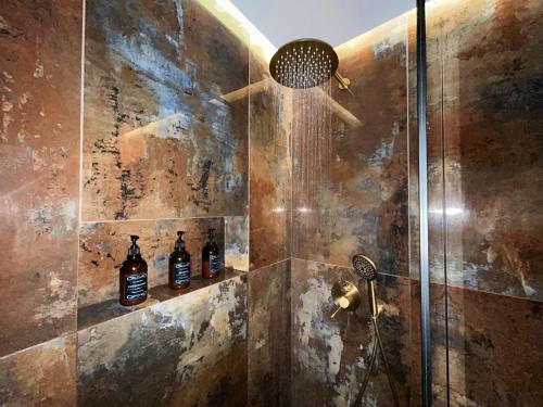a bathroom with a shower with a shower head at KLEOPATRA'S Luxury Suite in Preveza