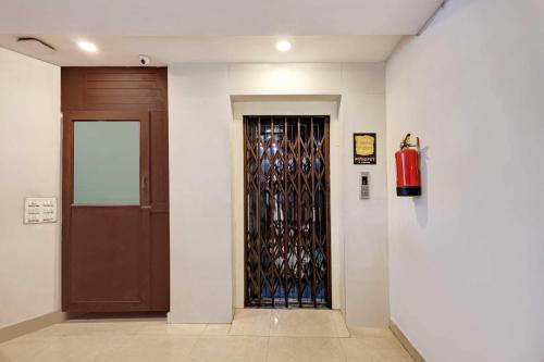a hallway with a door with a bunch of wine bottles at Hotel O Jagadamba Junction in Visakhapatnam